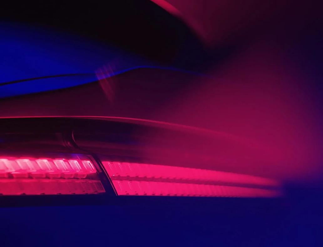 Close-up of a Hyundai car’s red LED taillight, reflecting the futuristic aesthetic of the corporate event’s visual identity.
