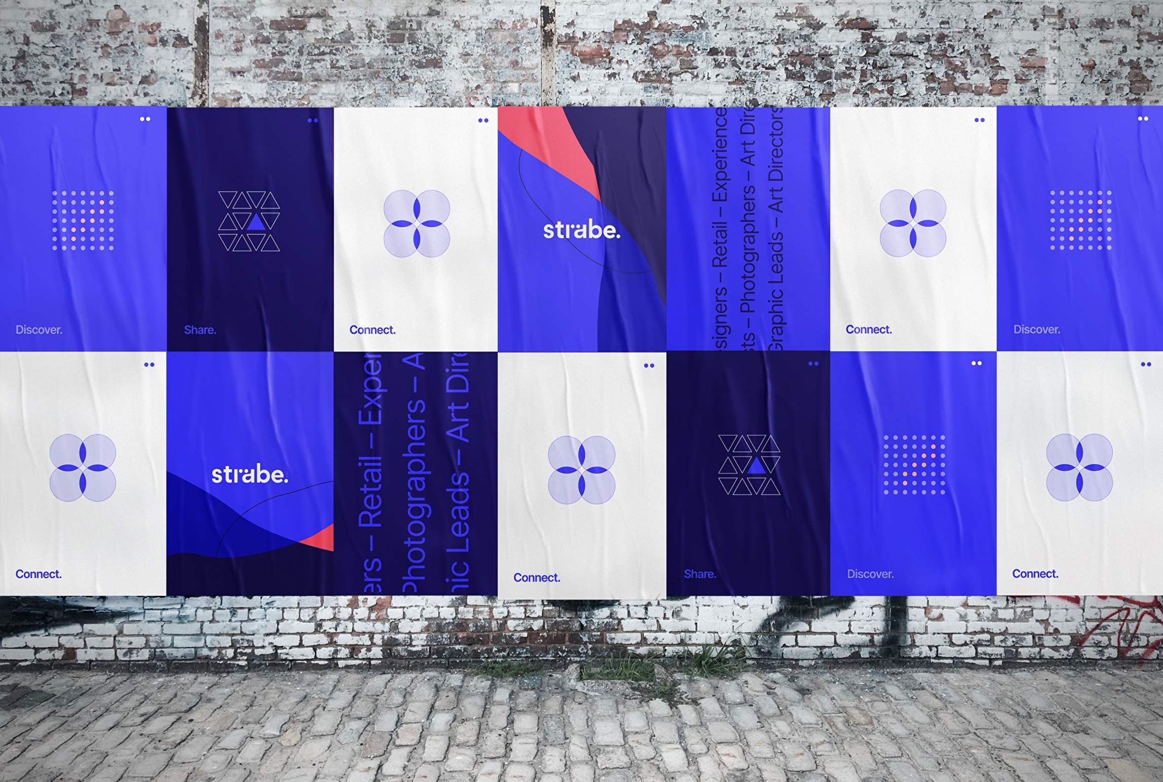 Corporate posters and icons on brick wall showcasing some Strabe brand identity elements.