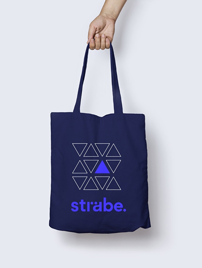 Implementation of the visual identity on a tote bag.